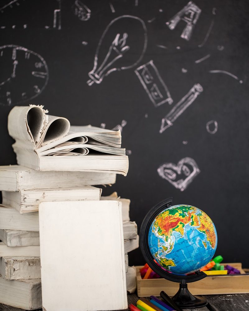 Books, a globe and learning tools on a desk