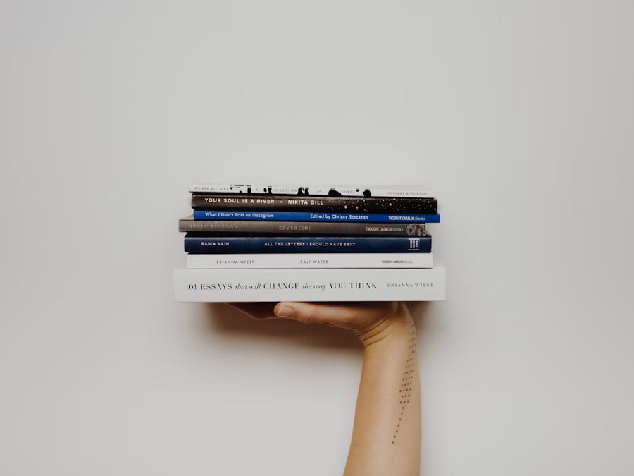 Stack of books and studies promoted by QOLOPP