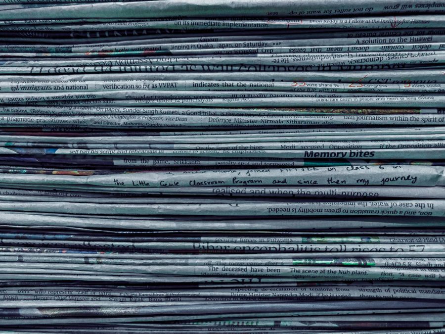 Stack of newspapers — development news and updates